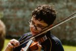 Young musicians playing a violin